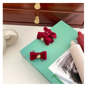 Close-up of vintage red velvet bow hair clips set with sparkling rhinestone centers