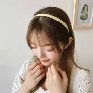 Yellow pleated fabric headband for girls, elegant wrinkled edge hair accessory on a model