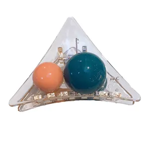 Transparent triangular hair claw with contrasting acrylic beads and rhinestones