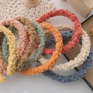 Detailed texture of colorful sherpa fleece hair hoops in various soft autumn colors