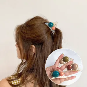Triangle claw clip with colorful round beads, shown worn and in close-up detail
