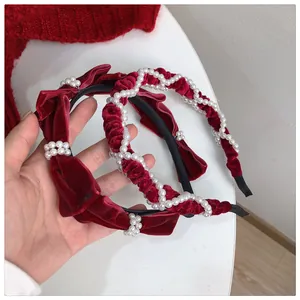 Close-up of wine red velvet headbands with pearls and French retro bow knot design