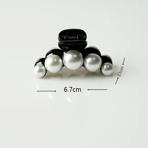 Detail view of medium black hair claw clip with faux pearls and size dimensions
