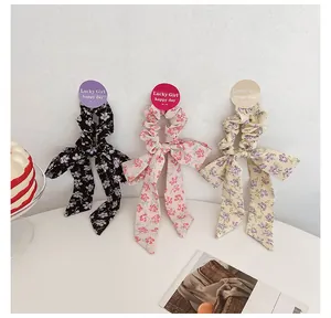 Floral bow scrunchie set with Lucky Girl tags in black, pink, and beige fabric