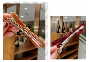 Detailed view of fabric bow hair clips in brown and wine red with sparkling rhinestones