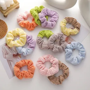 Detailed view of knitted waffle fabric scrunchies in pastel macaron and contrast colors