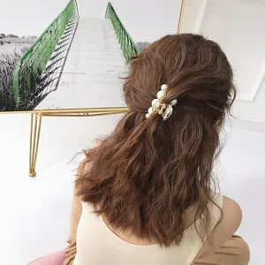 French style pearl hair claw clip for women shown on long wavy brown hair accessory