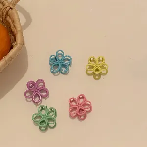Detail of candy-colored flower hair claws in pastel blue, yellow, and pink shades