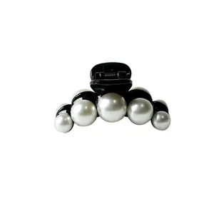 French style hair claw clip featuring elegant white pearls on a sleek black finish
