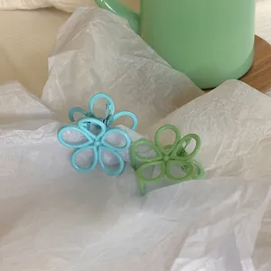 Pastel blue and green flower hair clips in a matte finish for a sweet aesthetic look