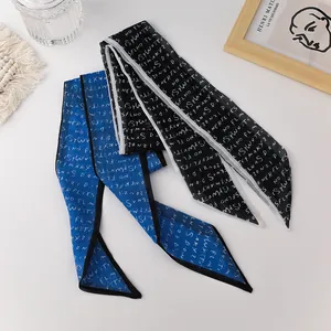 Close-up of French style organza skinny scarves with elegant letter print and fine edges