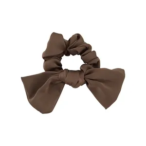 Elegant coffee brown satin hair scrunchie with oversized bow for French style hairstyle