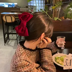 Elegant large red velvet bow hair claw clip for women in a vintage aesthetic style