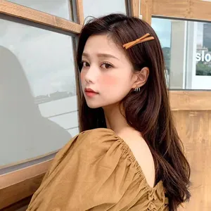 Elegant brown bow hair clip worn by model for a minimalist aesthetic look