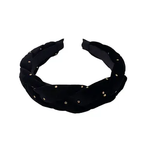 Braided black velvet headband with gold polka dots for a high-volume hair look