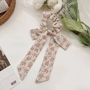 Floral print hair scrunchie with bow ribbon in cream and pink blossoms for women