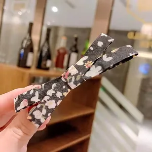 Cute Korean floral bow hair clip with black fabric and colorful flower patterns for women