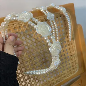 Elegant double-layer pearl headband featuring vintage white rose floral embellishments
