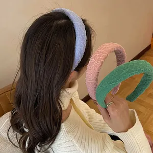 Detailed view of three candy-colored mesh sponge headbands in blue, pink, and green colors