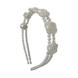 Elegant vintage double-row pearl headband featuring decorative white rose flowers