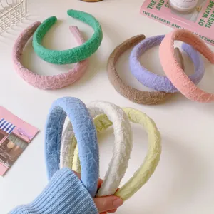 Detail view of colorful ruched fabric padded headbands in various candy pastel shades