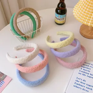 Detail of candy-colored sponge headbands with pleated mesh texture in various pastel shades