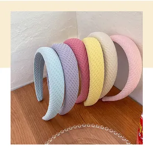 Detailed view of six colorful sponge headbands with a waffle texture on a wooden desk