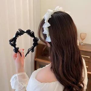 Detail of elegant mesh bow headband featuring sparkling crystal accents in white and black