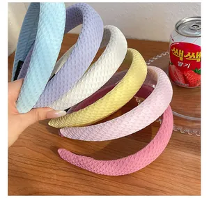 Detail of colorful padded sponge headbands with thick textured fabric and handmade label