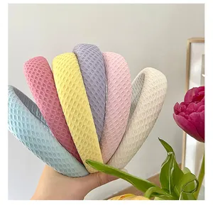 Close-up of colorful sponge headbands with waffle texture in assorted pastel shades