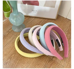 Detailed close-up of colorful waffle fabric headbands with handmade interior labels