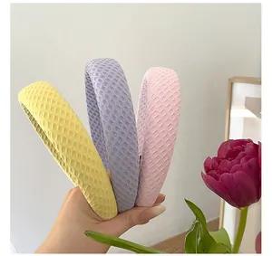 Three-piece set of waffle texture headbands in soft yellow, lilac, and pink colors