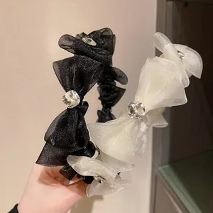 Detail of elegant mesh bow headbands with shimmering glitter and center rhinestone accents