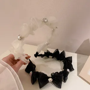 Detail of elegant organza bow headband featuring large sparkling crystals