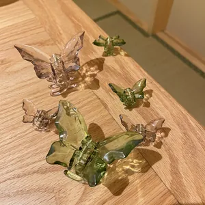 Translucent butterfly hair claws in various sizes and colors on a wooden surface