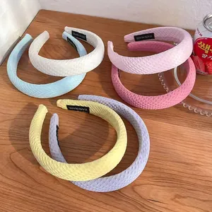 Padded candy color headband set with quilted texture and handmade label on wood background