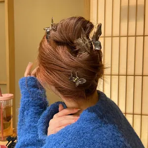 Detail of translucent butterfly hair claw clips in a stylish half-up hairstyle
