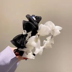 Detail of French style organza bow headbands with large crystals in black and white