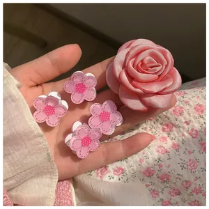 Detailed set of pink satin rose hair clip and four small polka dot acrylic floral hairpins