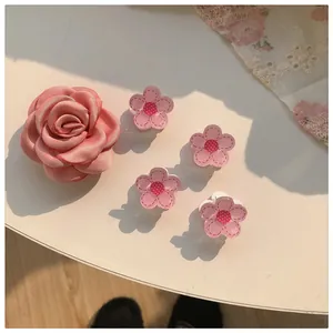 Detailed set of pink floral hair clips featuring satin rose and small petal claw clips