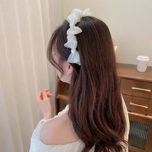 Elegant beige organza bow headband for women featuring shimmering rhinestone accents