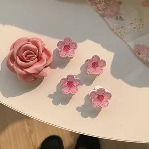 Pink floral camellia hair clips with white stitching and polka dot details