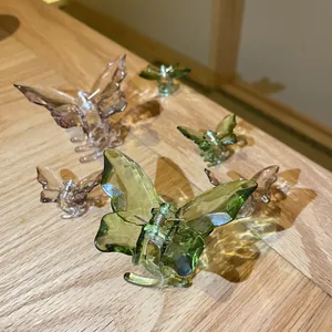 Detail of translucent butterfly hair claws in green and purple on wood surface