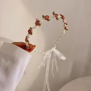 Pink rose and pearl headband with white lace ribbons for an elegant floral hair look