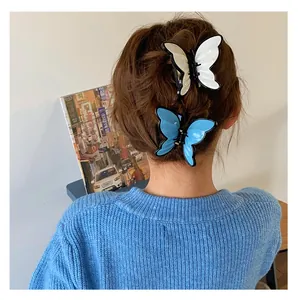 Close-up of elegant butterfly hair claw clips in blue and silver on a model's hair