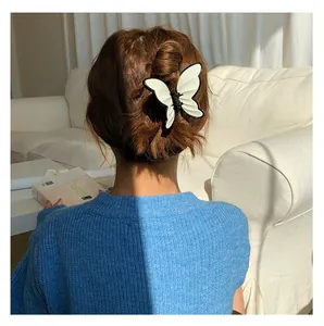 Detail view of the black and white butterfly hair claw with 3D wavy texture on model