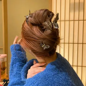 Translucent crystal butterfly hair claw clips on long wavy hair for elegant styling