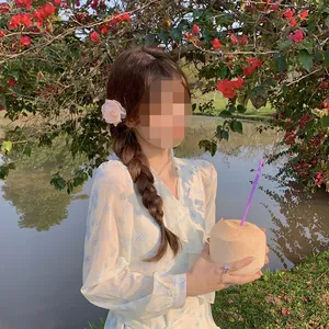 Elegant floral chiffon dress with camellia hair clip in a scenic outdoor lakeside setting
