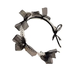Elegant double-row pearl headband with delicate black mesh bows and rhinestone accents