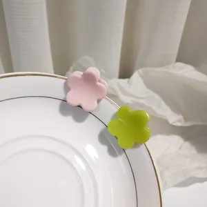 Chic cream flower hair claws in light pink and green resin for stylish daily hair styling